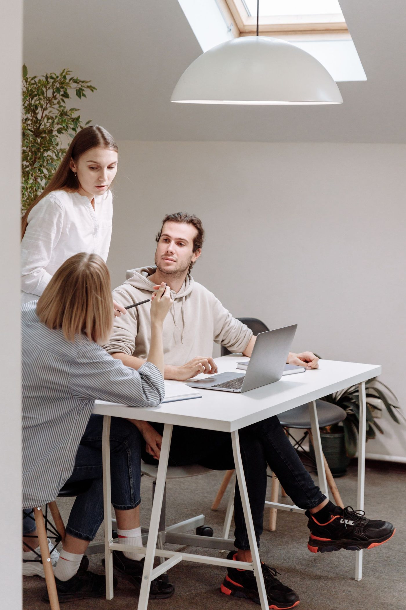A small team working through ideas together at a desk.